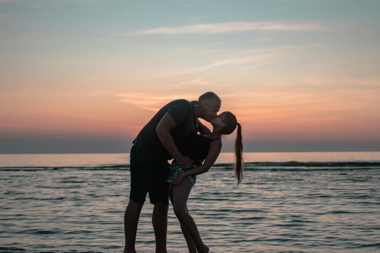 a man and a woman kissing on the beach, pexels contest winner, end of day, full body image, instagram post, 1 2 9 7