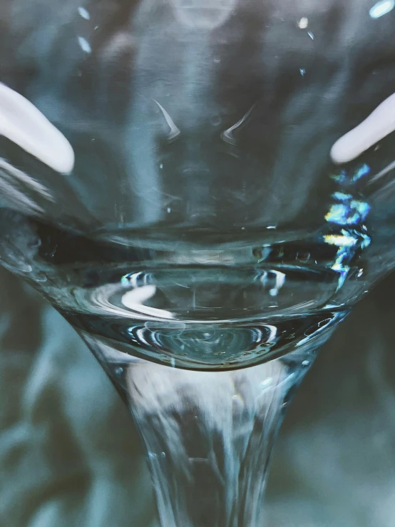a close up of a wine glass on a table, inspired by Carlo Martini, trending on unsplash, hyperrealism, made of water, 1960s color photograph, ilustration, brandon woelfel