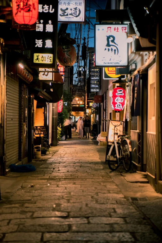 a narrow alley in an asian city at night, a picture, inspired by Kanō Naizen, trending on unsplash, mingei, dimly lit dive bar, summer evening, cobblestone street, fujifilm”