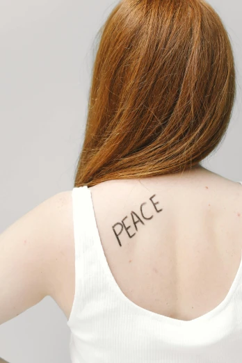 a woman with a peace tattoo on her back, by Hannah Tompkins, trending on pexels, sadie sink, courtesy of moma, promo photo, taken in the late 2010s