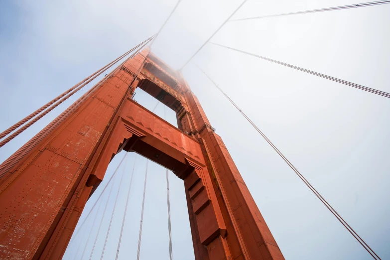 a view of the golden gate bridge from below, by Sven Erixson, unsplash, hypermodernism, slide show, low angle mist, rust, high - angle view