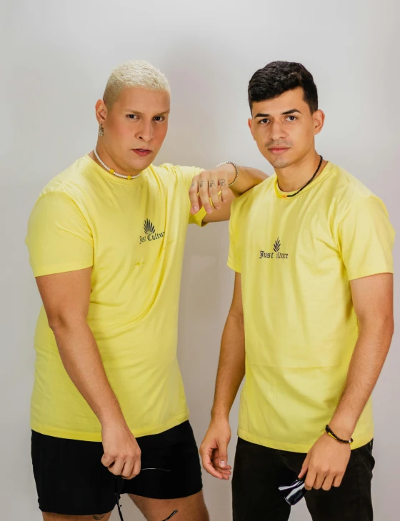 a couple of men standing next to each other, a portrait, by Robbie Trevino, wearing a modern yellow tshirt, 8k octan photo, pose 4 of 1 6, colombian