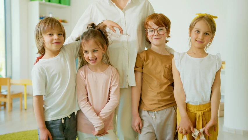 a woman standing next to a group of children, trending on pexels, incoherents, cute and lovely, nerds, proportional image, promotional image