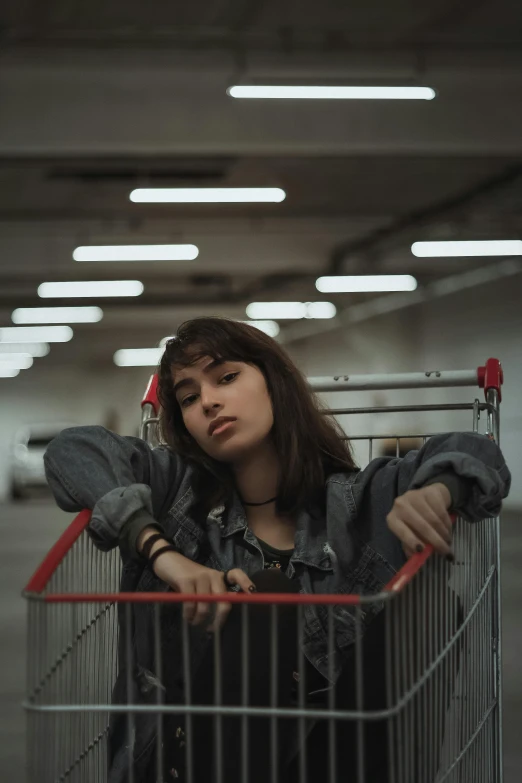 a woman sitting in a shopping cart in a parking garage, pexels contest winner, realism, handsome girl, dark mood, cynthwave, concert