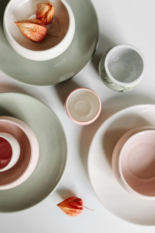 a couple of bowls sitting on top of a table, inspired by Giorgio Morandi, trending on unsplash, green and pink colour palette, place setting, zoomed in, color”