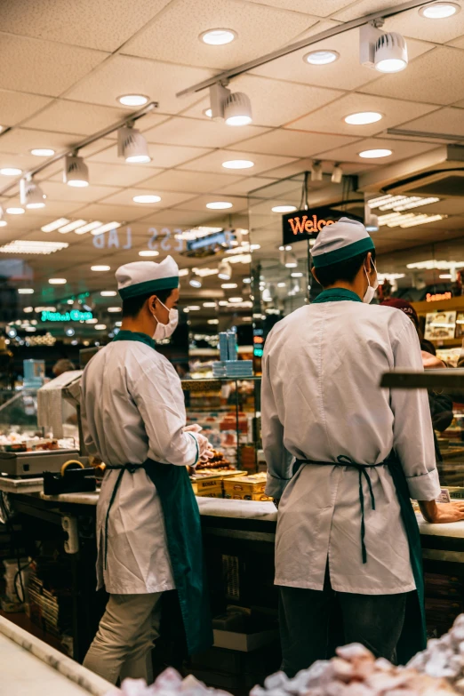 a couple of people that are standing in front of a counter, pexels contest winner, starbucks aprons and visors, inside a supermarket, 2 5 6 x 2 5 6 pixels, hong kong