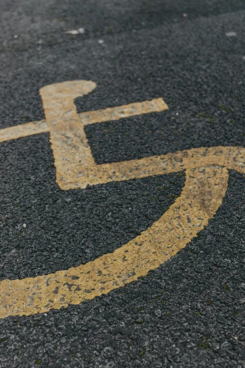 a handicap sign painted on the side of a road, by James Morris, unsplash, auto-destructive art, square, gold, in scotland, chalk