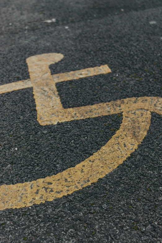 a handicap sign painted on the side of a road, by James Morris, unsplash, auto-destructive art, square, gold, in scotland, chalk