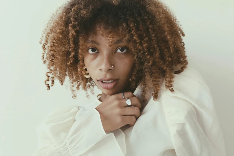 a close up of a person wearing a white shirt, inspired by Theo Constanté, trending on pexels, curly bangs, elden ring style, black teenage girl, neutral pose