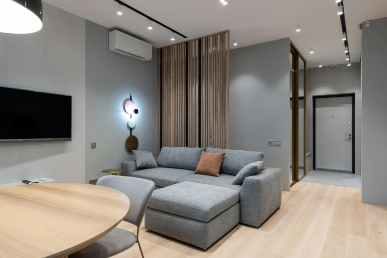 a living room filled with furniture and a flat screen tv, by Adam Marczyński, light and space, light grey blue and golden, neo kyiv, electrical, high quality photo
