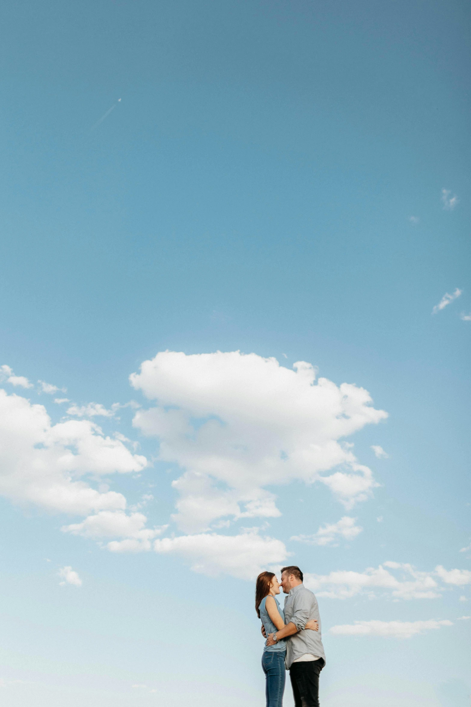 a man and woman standing in front of the eiffel tower, unsplash, beautiful sky with cumulus couds, minimalist photo, ryan mcginley, wedding