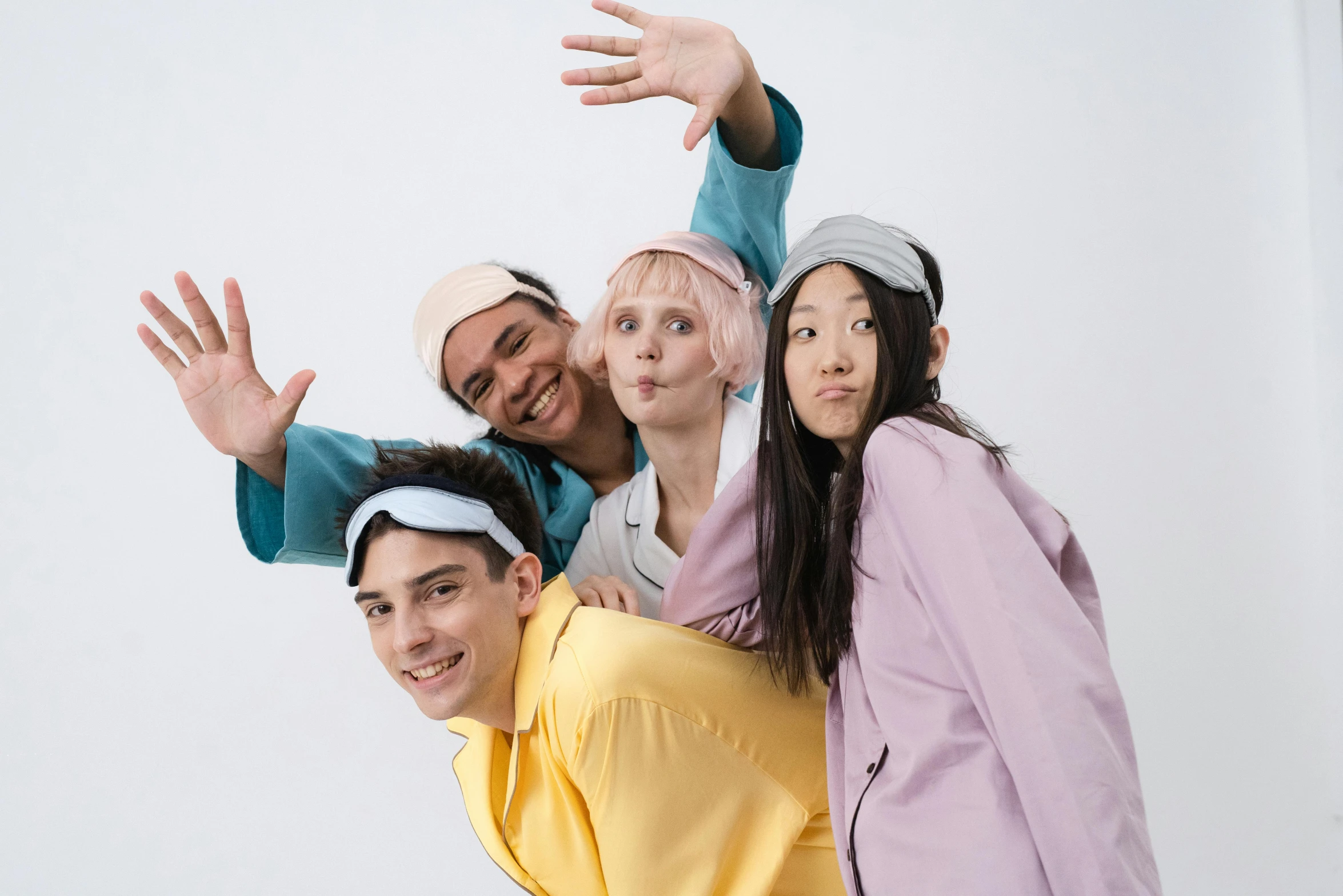 a group of people posing for a picture, an album cover, inspired by Jean-Étienne Liotard, trending on pexels, antipodeans, anime cosplay, issey miyake, hairband, photoshoot for skincare brand