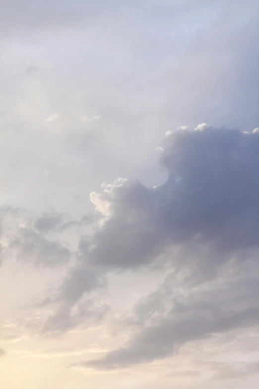 a man flying a kite on top of a lush green field, by Linda Sutton, layered stratocumulus clouds, soft light - n 9, grey, color photograph