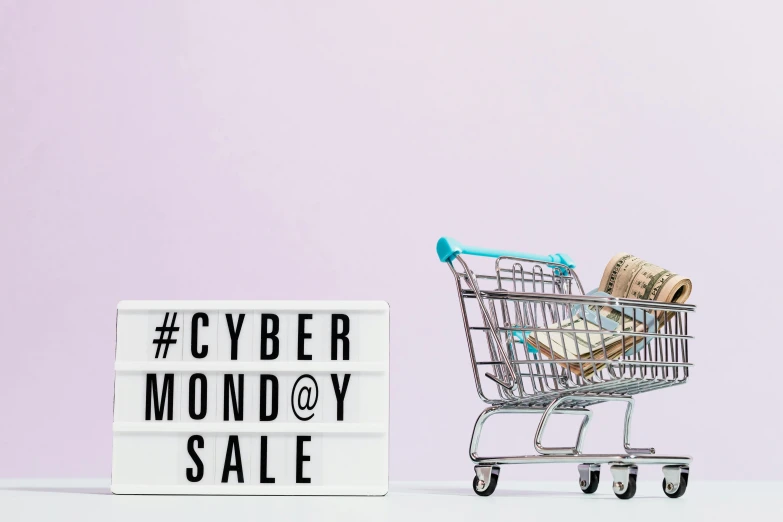 a shopping cart sitting next to a sign that says cyber monday sale, a photo, by Julia Pishtar, shutterstock, modernism, worksafe. instagram photo, ad image, mummy, mint