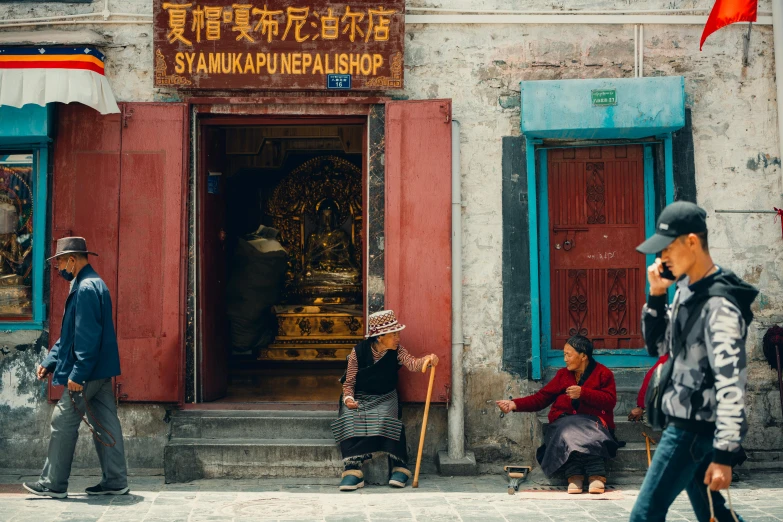 a group of people standing in front of a building, unsplash contest winner, cloisonnism, tibet, quirky shops, square, deep colours. ”