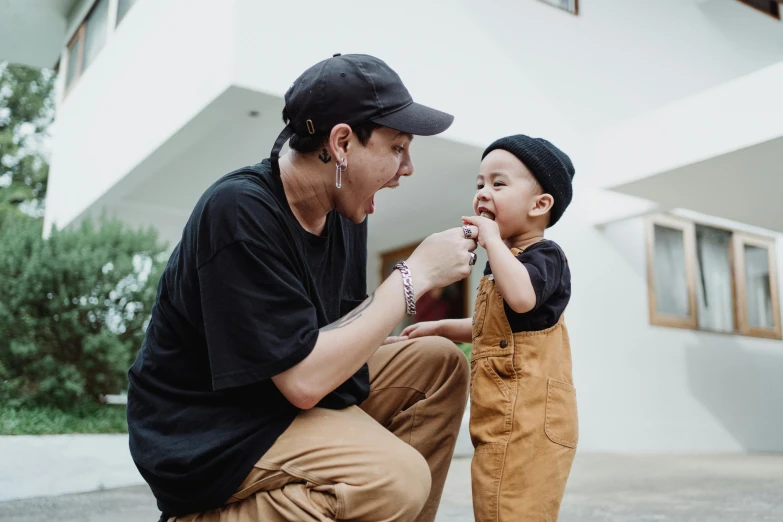 a man kneeling down next to a little boy, pexels contest winner, zigor samaniego style, tongue, jordan grimmer and natasha tan, profile image