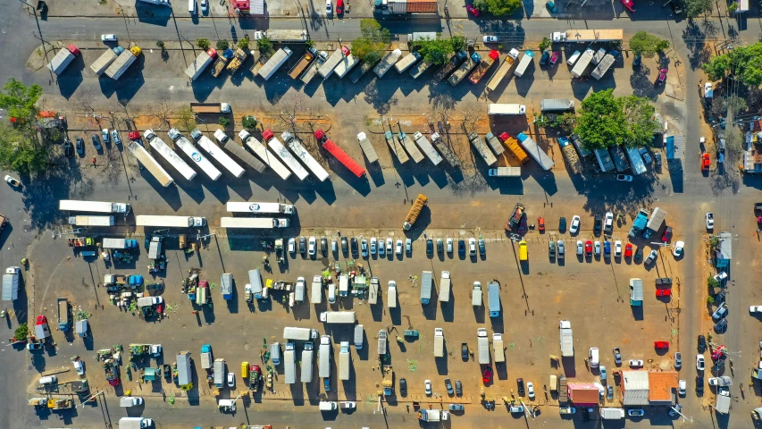 a parking lot filled with lots of parked trucks, pexels contest winner, buenos aires, thumbnail, square, drone footage