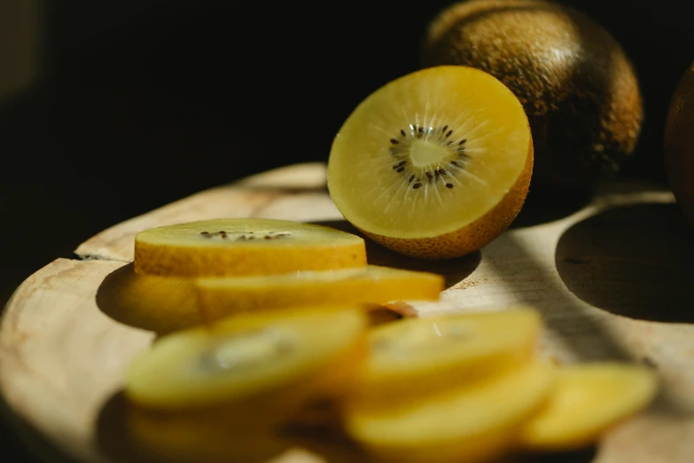 a sliced kiwi sitting on top of a wooden cutting board, a still life, by Kristin Nelson, pexels, hurufiyya, with a bright yellow aureola, thumbnail, pear, brown