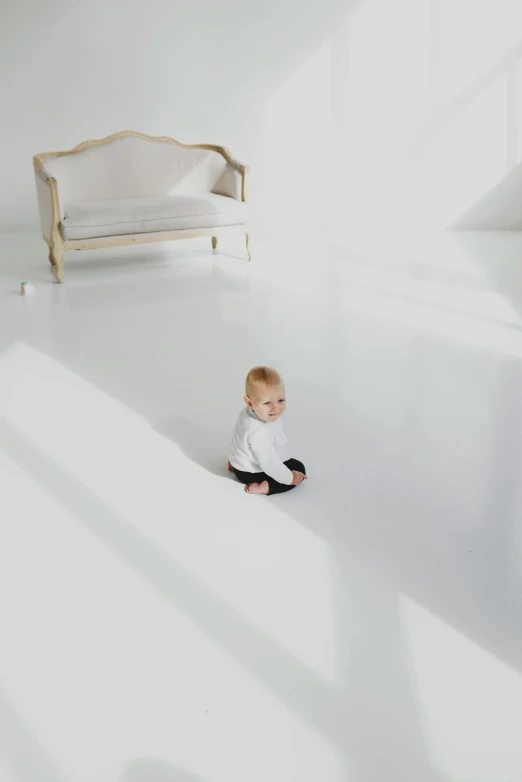 a baby sitting on the floor in a white room, by Winona Nelson, minimalism, glossy white metal, dramatic. fantasy, white, lux