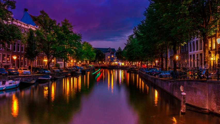 a canal filled with lots of boats next to tall buildings, by Jan Tengnagel, pexels contest winner, romanticism, purple and yellow lighting, delft, city lights made of lush trees, drinking