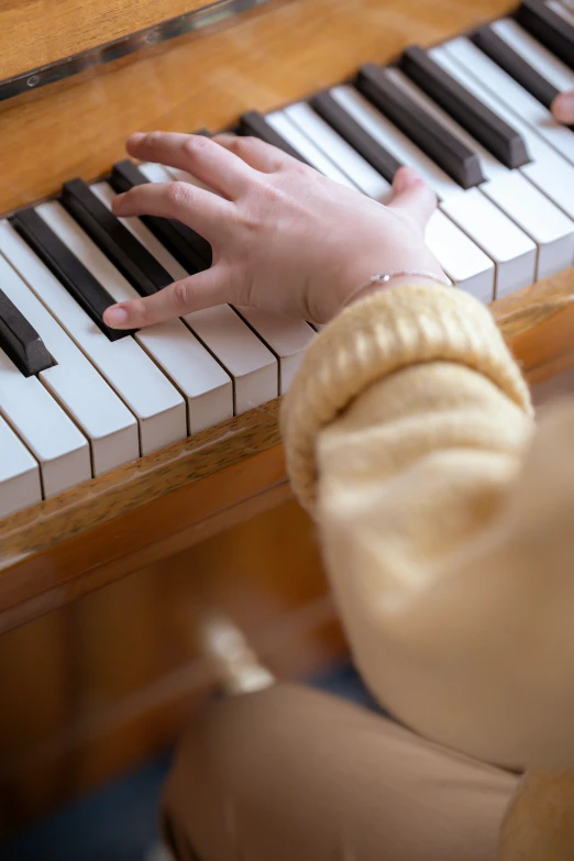 a close up of a person playing a piano, hands straight down, student, precious moments, brown