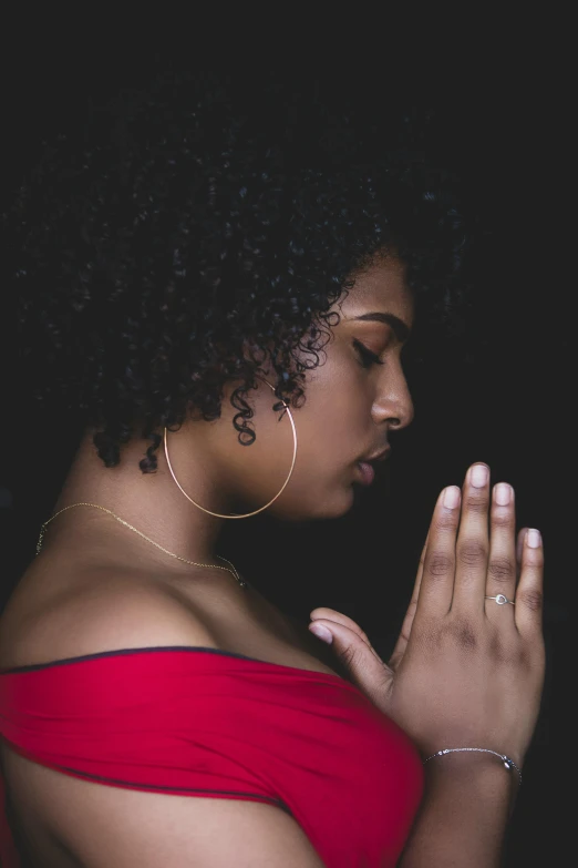 a woman in a red dress is praying, an album cover, by Lily Delissa Joseph, pexels, afro, anjali mudra, thicc, profile pic