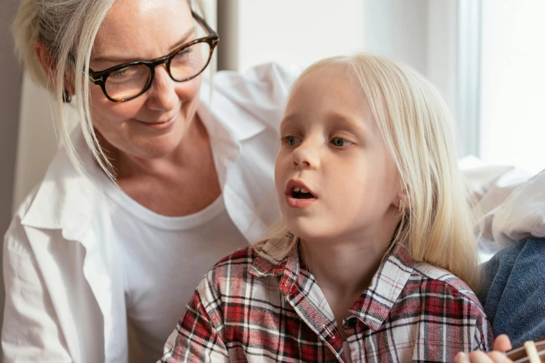 a woman teaching a little girl how to play guitar, pexels contest winner, art & language, wearing lab coat and glasses, vocal tract model, girl with short white hair, lachlan bailey