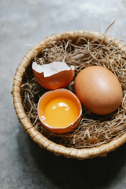 a basket filled with eggs sitting on top of a table, a still life, trending on pexels, aji de gallina, with a soft, “organic, vanilla