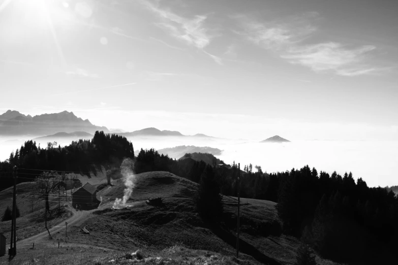 a black and white photo of a mountain, a black and white photo, by Matthias Weischer, pexels contest winner, figuration libre, morning atmosphere, countryside, fume, panorama view