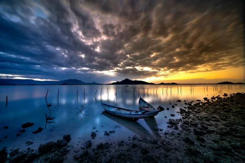 a boat sitting on top of a lake under a cloudy sky, by Ibrahim Kodra, unsplash contest winner, romanticism, dramatic lighing, lagoon, album, hd footage