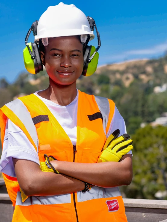 a woman in an orange safety vest and headphones, pexels contest winner, a green, wearing gloves, avatar image, civil engineer