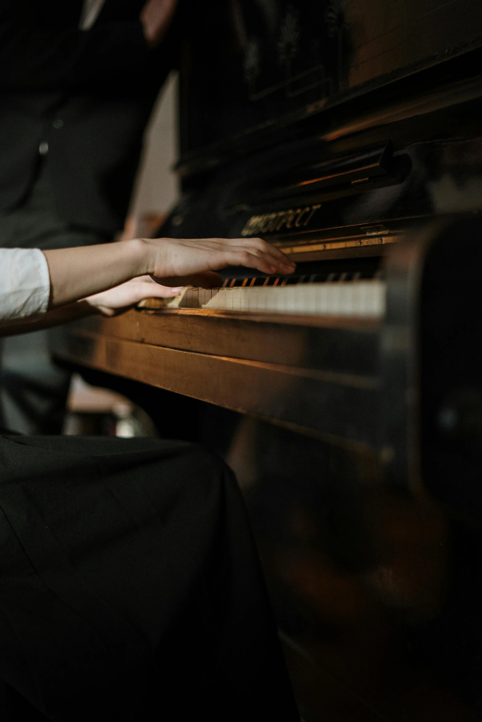 a close up of a person playing a piano