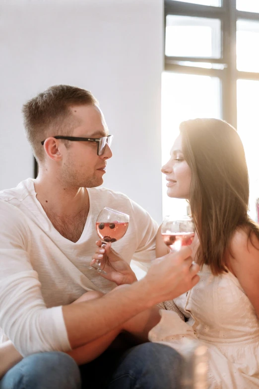 a man and a woman sitting on a couch holding wine glasses, pexels contest winner, renaissance, making out, on a white table, caucasian, vine