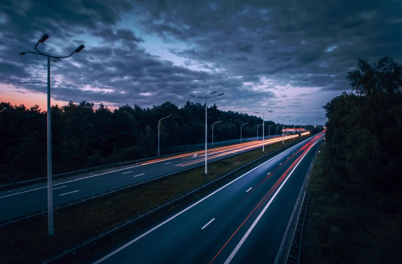 a highway filled with lots of traffic under a cloudy sky, by Jacob Toorenvliet, pexels contest winner, realism, predawn, thumbnail, speed lines, full frame image