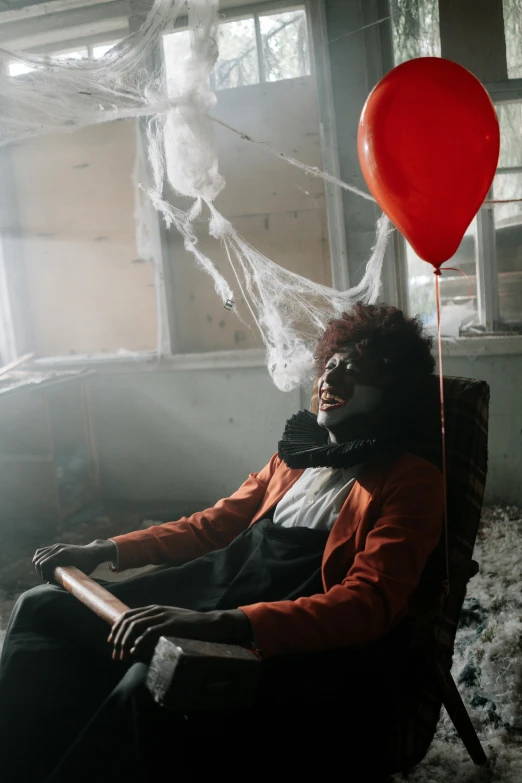 a woman sitting in a chair with a red balloon, inside haunted house, with afro, ignant, slide show