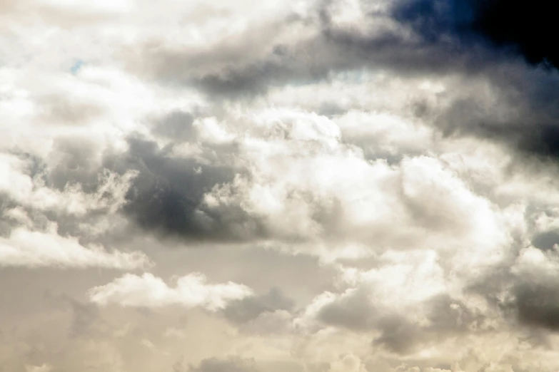 a large jetliner flying through a cloudy sky, an album cover, by Carey Morris, unsplash, baroque, layered stratocumulus clouds, today\'s featured photograph 4k, close-up photograph, cumulus clouds