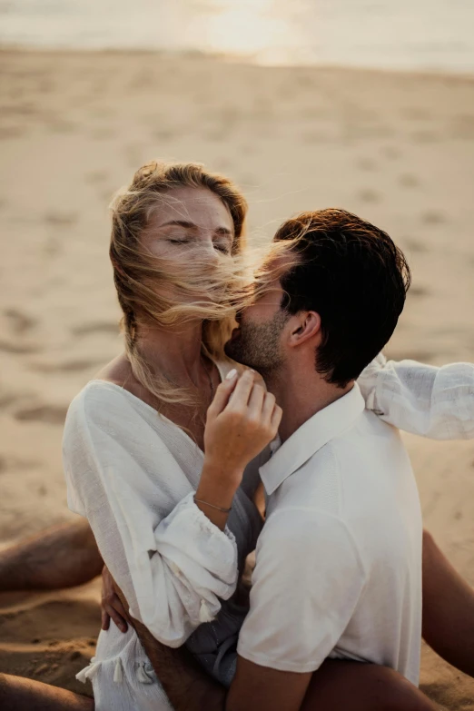 a man kissing a woman on the beach, by Daniel Lieske, pexels contest winner, renaissance, wearing a white button up shirt, hair blowing, dune, gif