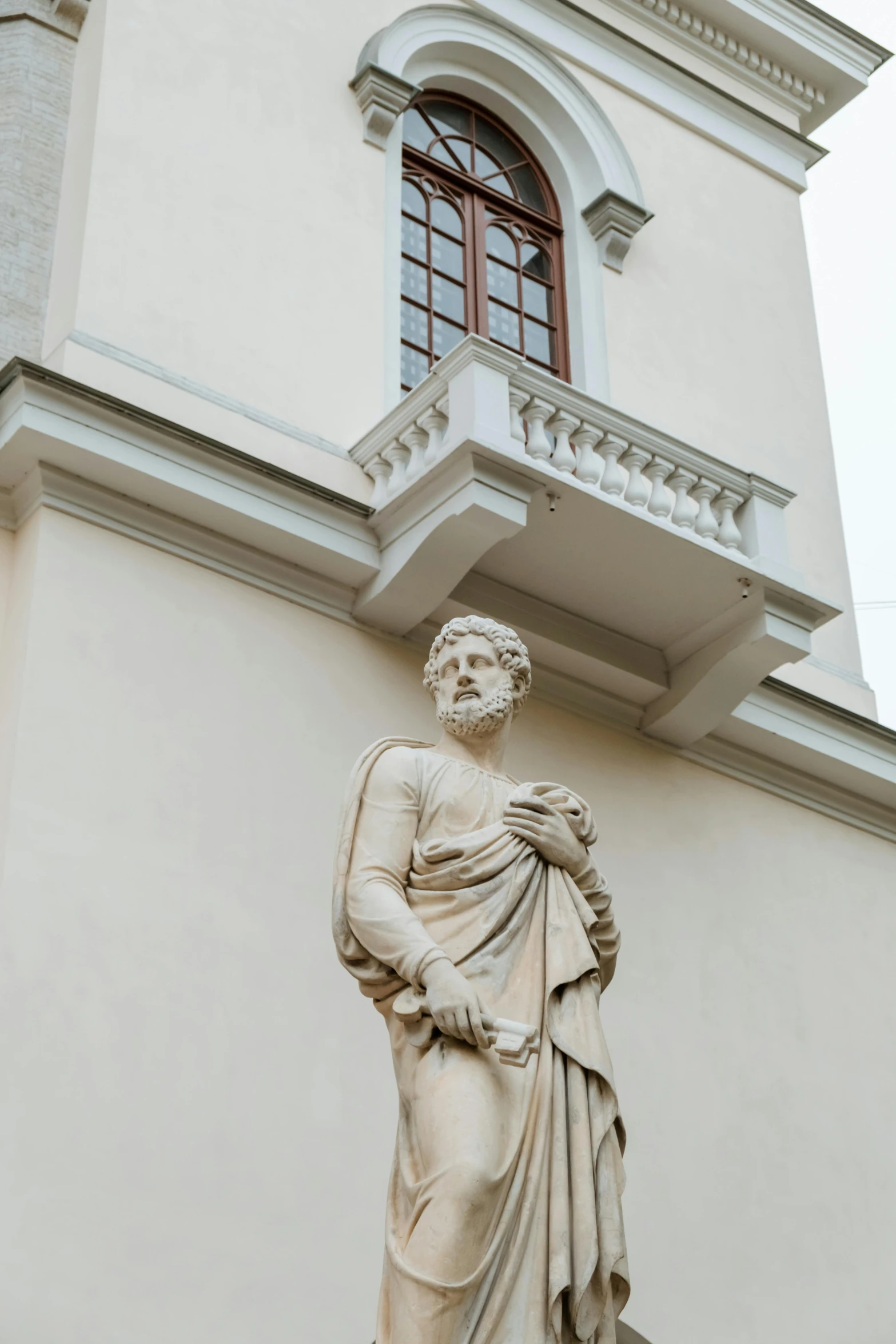 a statue of a man standing in front of a building, inspired by Károly Markó the Elder, neoclassicism, bearded, julia sarda, holes in a religious man, upper body image