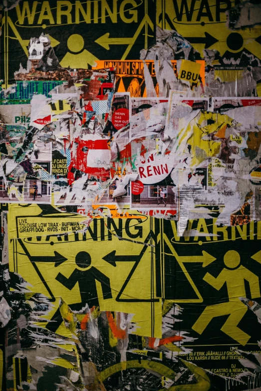 a bunch of stickers that are on a wall, inspired by Mimmo Rotella, trending on pexels, high voltage warning sign, body breaking apart, photo taken at night, people at work