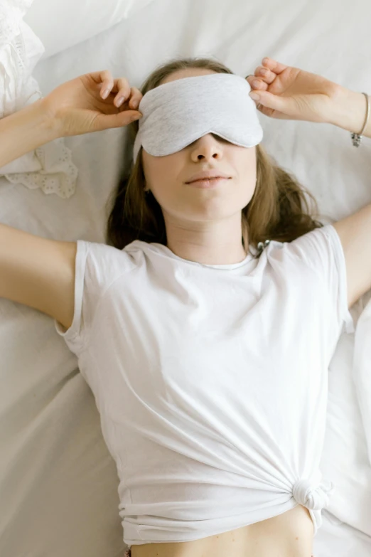 a woman laying in bed with her eyes closed, trending on pexels, renaissance, wearing an eye patch, wearing a light shirt, soma, masked