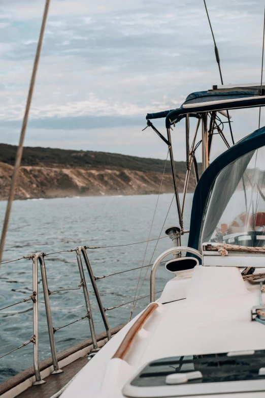 a close up of a boat on a body of water, pexels contest winner, hills and ocean, on a yacht at sea, south african coast, canvas