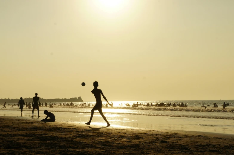 a group of people playing soccer on a beach, an album cover, by Sudip Roy, pexels contest winner, afternoon sun, quiet beauty, sunburn, ignant
