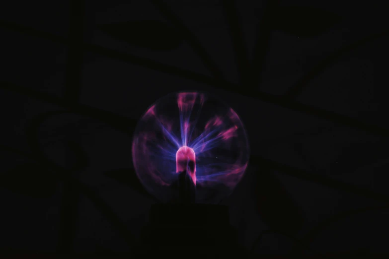 a person holding a plasma ball in their hand, by Anna Füssli, unsplash, purple. ambient lightning, caustic projection, pink, emerging from a lamp