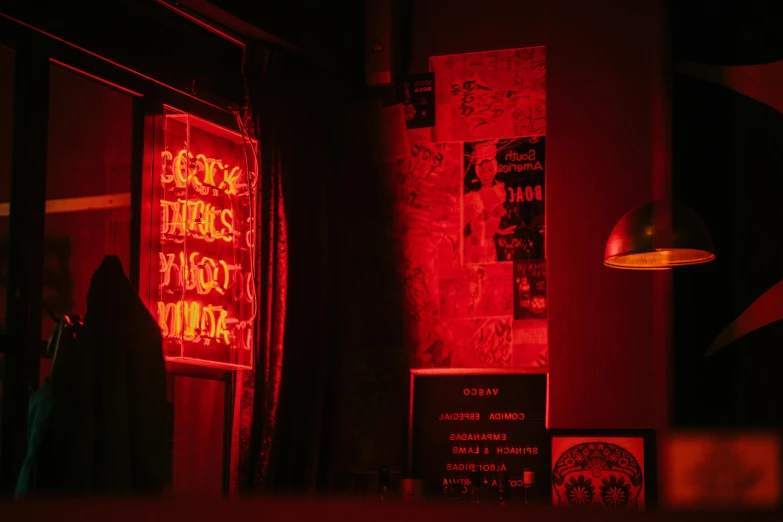 a red neon sign sitting on the side of a building, inspired by Elsa Bleda, pexels contest winner, inside a bar, a magician's chamber, closed limbo room, warm lighting inside
