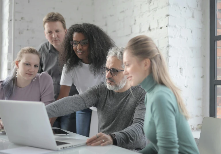 a group of people gathered around a laptop, trending on pexels, renaissance, grey, small, professional photo, teaching