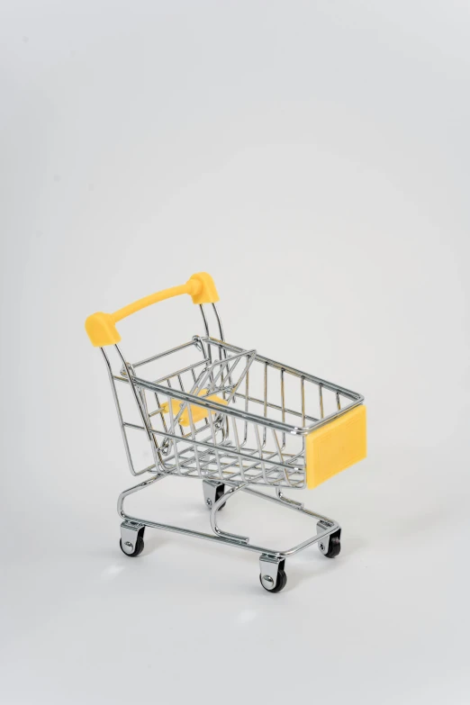 a small shopping cart on a white background, by Matthias Stom, pexels, silver and yellow color scheme, square, 1:87, thumbnail