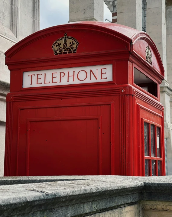 a red telephone booth sitting on the side of a building, slide show, lgbtq, old english, trending photo