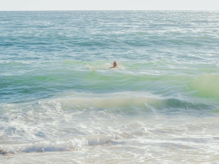 a man riding a wave on top of a surfboard, by Liza Donnelly, unsplash contest winner, renaissance, green bikini, sparsely populated, australian beach, santa monica beach