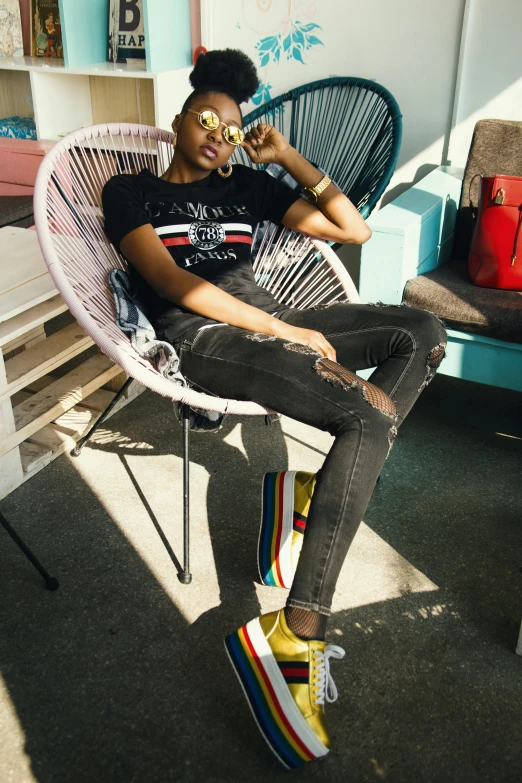 a woman sitting in a chair in a room, a photo, inspired by Gina Pellón, trending on pexels, pop art, jeans and t shirt, at the terrace, afropunk, gucci