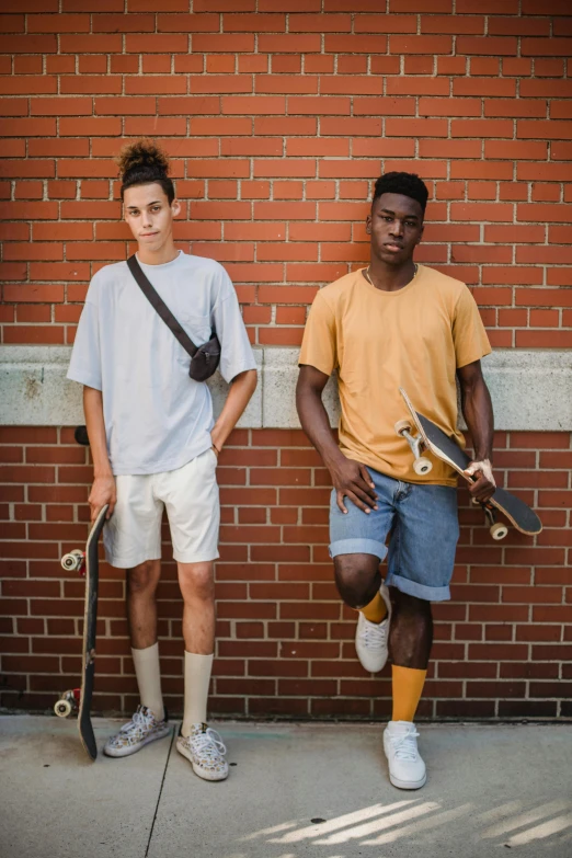 two young men standing next to each other with skateboards, by Andrew Stevovich, muted browns, black teenage boy, promotional image, live action movie